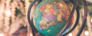 Vintage globe close up, with the globe centered on Africa and the Middle East. Photo by Artem Beliaikin via Unsplash.